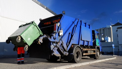 East Ham resident placing waste in collection bin