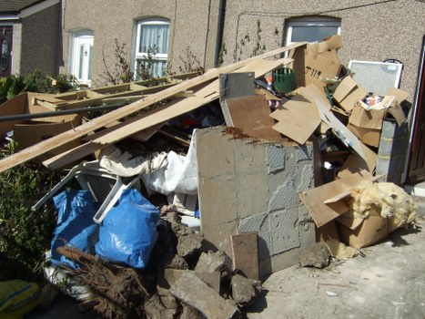 Bulky waste items being loaded by council workers in The Hale